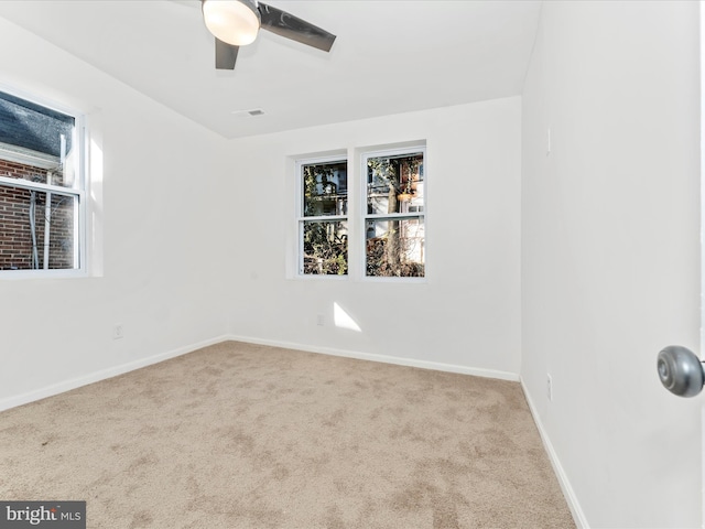 unfurnished room featuring light carpet and ceiling fan