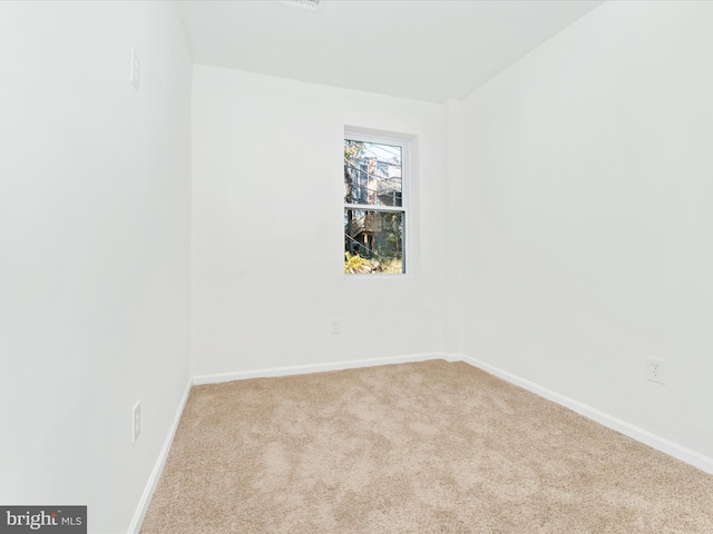 spare room with light colored carpet