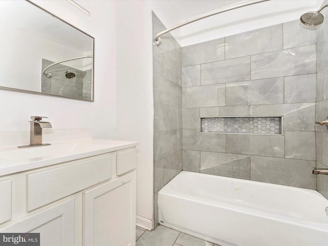 bathroom featuring vanity, tile patterned floors, and tiled shower / bath