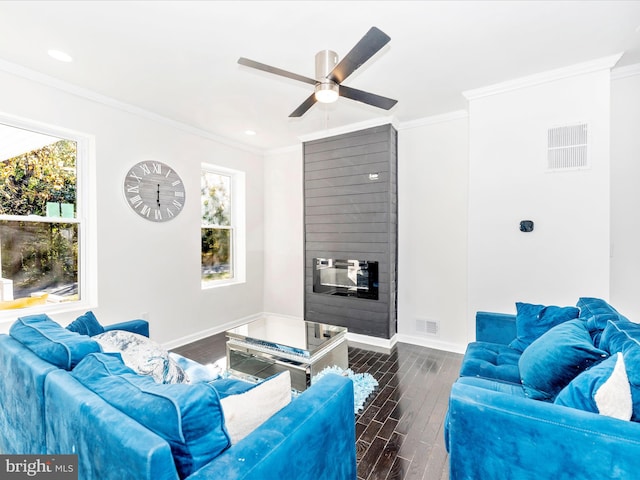 living room with ornamental molding, ceiling fan, and dark wood-type flooring