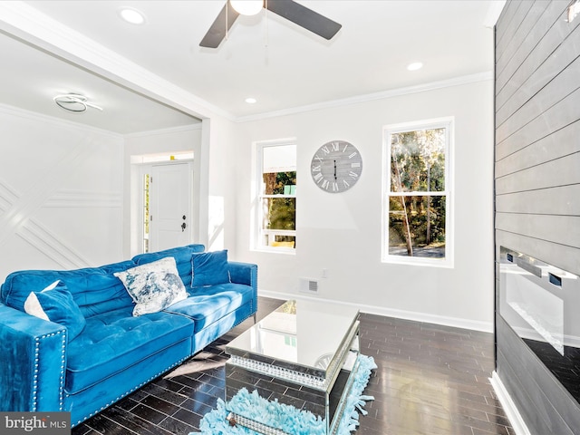 living room featuring a wealth of natural light, dark hardwood / wood-style flooring, and crown molding