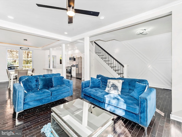 living room featuring ceiling fan, crown molding, and dark wood-type flooring