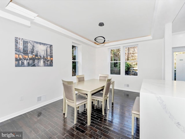 2592 Druid Park Dr, Baltimore, MD 21215 - dining room with a raised ceiling, baseboards, dark wood-style floors, and crown molding