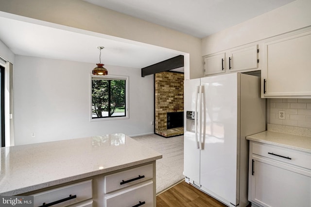 9103 Home Guard Dr, Burke, VA 22015 - kitchen featuring white fridge with ice dispenser, backsplash, light stone countertops, pendant lighting, and wood finished floors