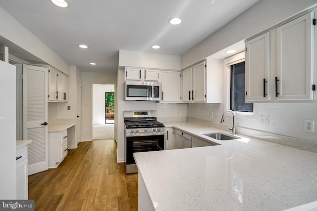 9103 Home Guard Dr, Burke, VA 22015 - kitchen featuring appliances with stainless steel finishes, a sink, plenty of natural light, light stone counters, and recessed lighting