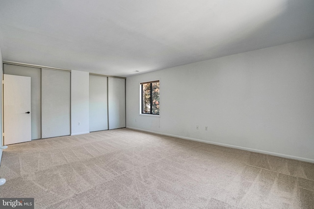 9103 Home Guard Dr, Burke, VA 22015 - unfurnished bedroom with two closets, carpet floors, and baseboards
