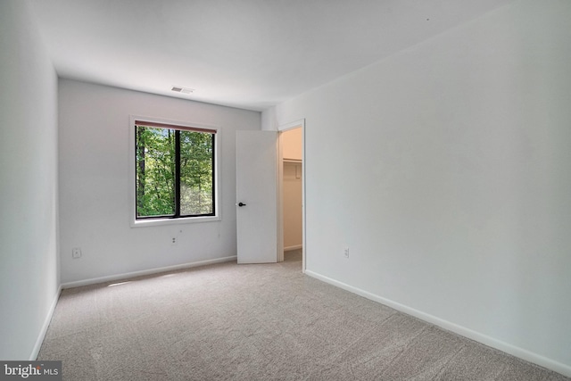 9103 Home Guard Dr, Burke, VA 22015 - unfurnished bedroom featuring carpet flooring, a walk in closet, and baseboards
