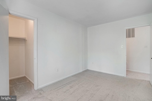 9103 Home Guard Dr, Burke, VA 22015 - unfurnished bedroom featuring a spacious closet, light carpet, baseboards, and a closet