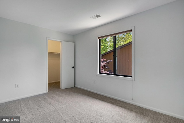 9103 Home Guard Dr, Burke, VA 22015 - unfurnished bedroom with carpet flooring, a walk in closet, baseboards, and a closet