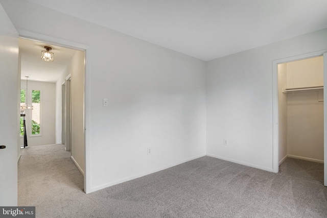 9103 Home Guard Dr, Burke, VA 22015 - unfurnished bedroom with carpet, a spacious closet, a chandelier, and baseboards