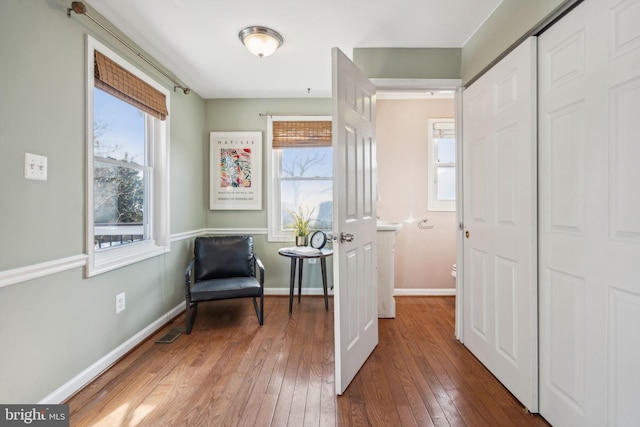 living area featuring dark hardwood / wood-style floors and a wealth of natural light