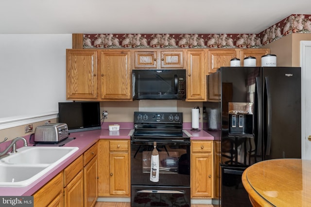 kitchen with sink and black appliances