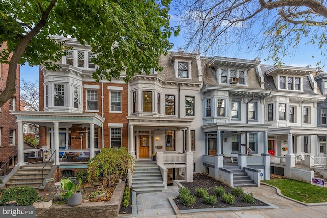 townhome / multi-family property featuring covered porch