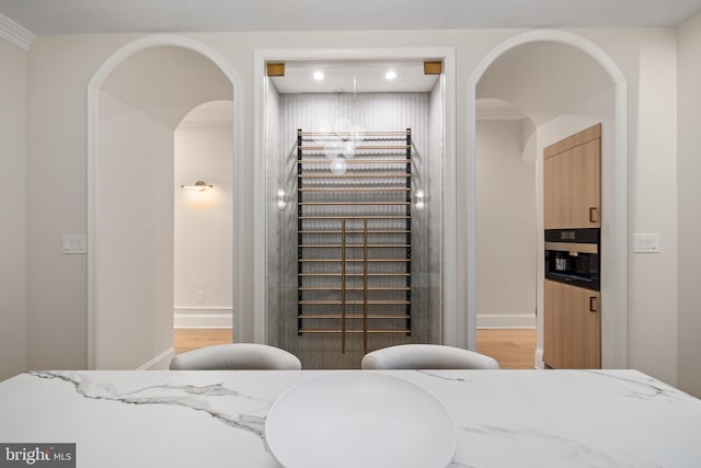 bedroom with light hardwood / wood-style floors and ornamental molding