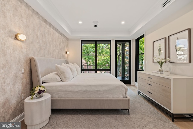 bedroom with ornamental molding and light hardwood / wood-style floors