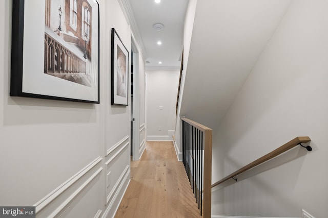 corridor featuring light hardwood / wood-style floors and ornamental molding