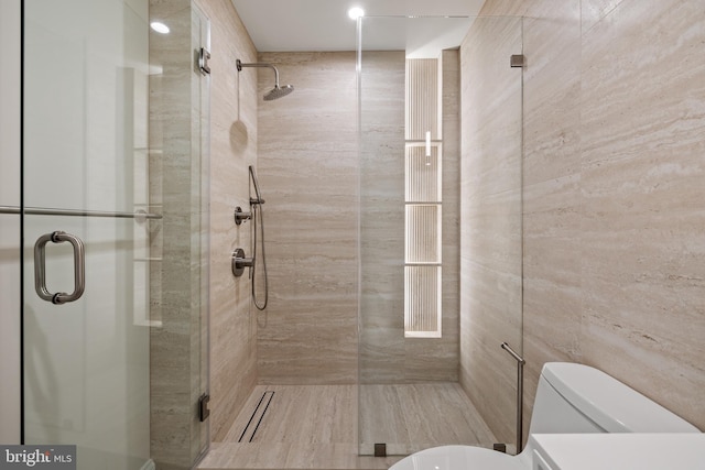 bathroom with walk in shower and toilet