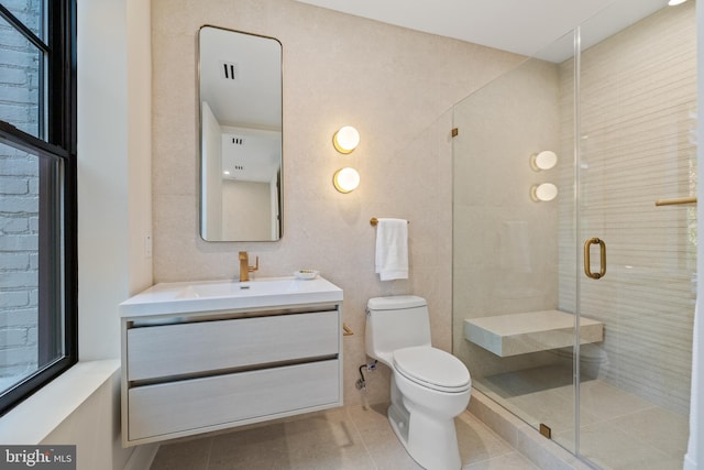 bathroom with walk in shower, tile patterned floors, vanity, and toilet