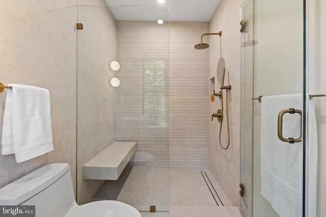 bathroom with toilet, an enclosed shower, and tile walls