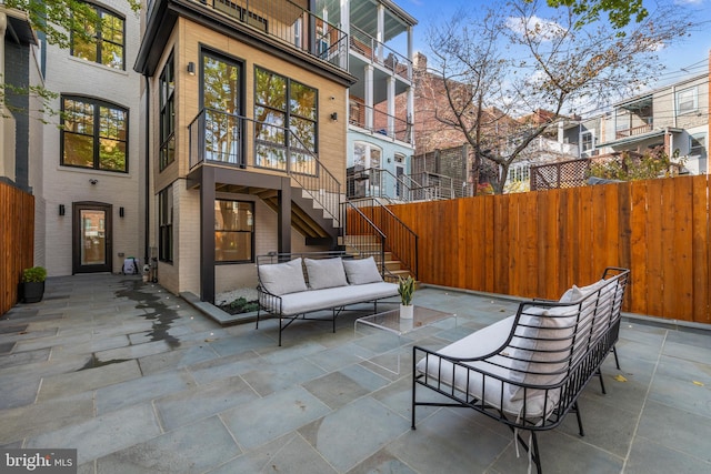 view of patio with a balcony and an outdoor living space