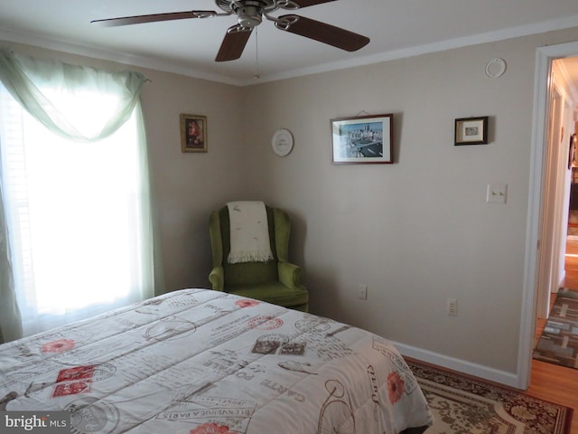 bedroom with light hardwood / wood-style floors, ceiling fan, and crown molding