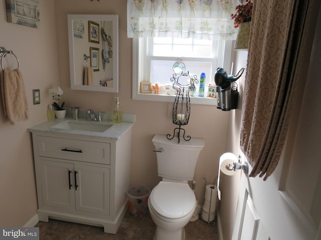 bathroom with tile patterned floors, vanity, and toilet