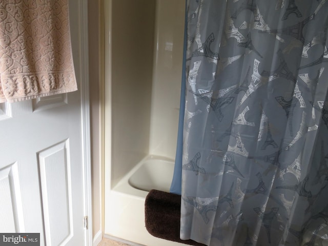 bathroom featuring shower / bathtub combination with curtain