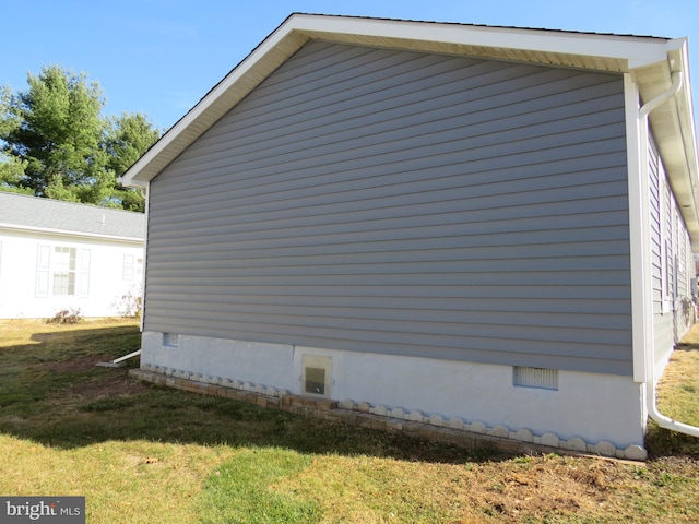 view of side of home with a lawn