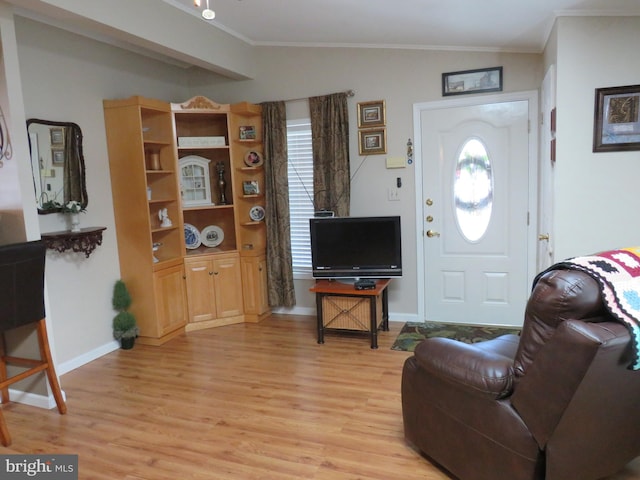 living room with light wood-type flooring, lofted ceiling, and crown molding