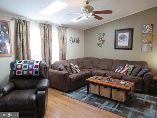 living room with light hardwood / wood-style floors, lofted ceiling, ceiling fan, and crown molding