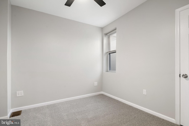 carpeted spare room with ceiling fan