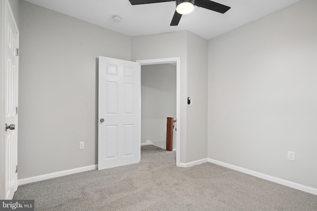 unfurnished bedroom with light colored carpet and ceiling fan