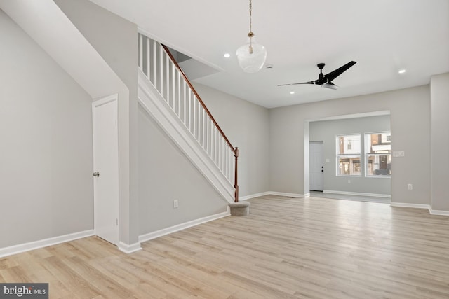 unfurnished living room with light hardwood / wood-style flooring and ceiling fan