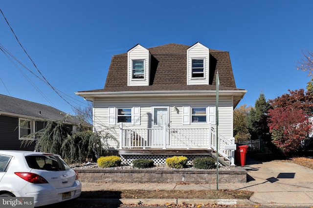 new england style home with covered porch