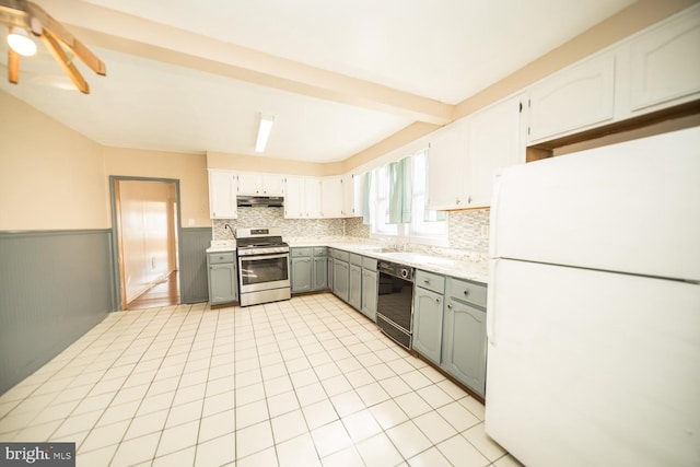 kitchen featuring tasteful backsplash, stainless steel stove, dishwasher, gray cabinetry, and white refrigerator