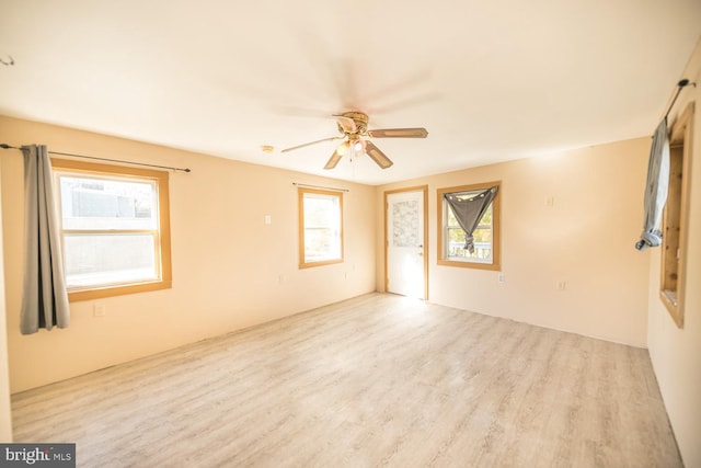 unfurnished room with ceiling fan and light wood-type flooring