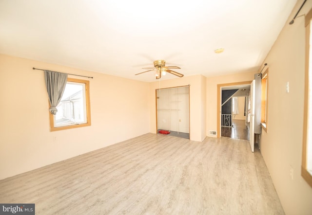 unfurnished bedroom with ceiling fan and wood-type flooring