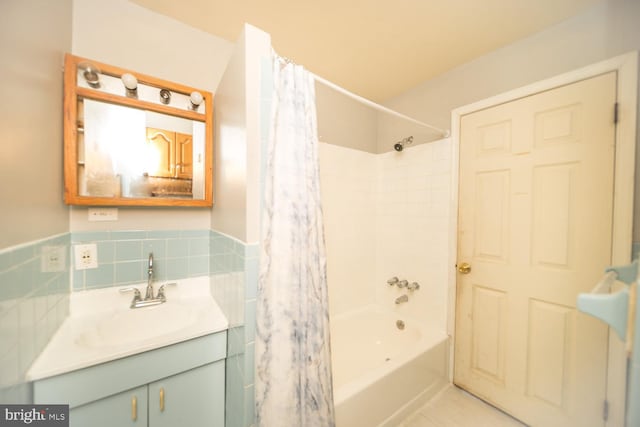 bathroom featuring vanity and shower / bathtub combination with curtain