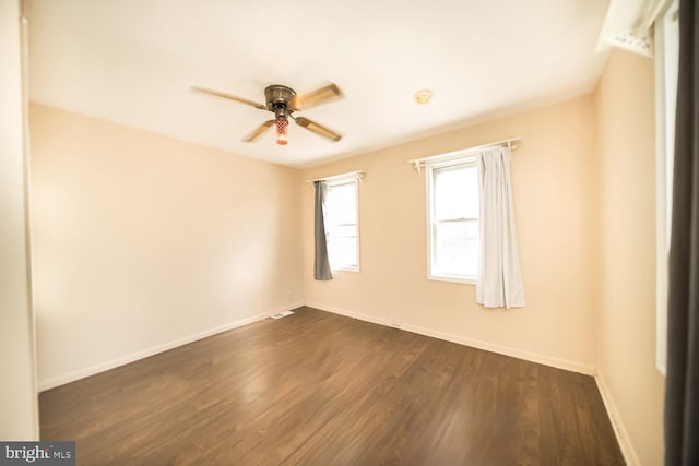 spare room featuring dark hardwood / wood-style floors and ceiling fan