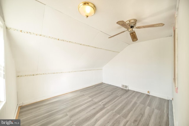 bonus room with ceiling fan, wood-type flooring, and lofted ceiling