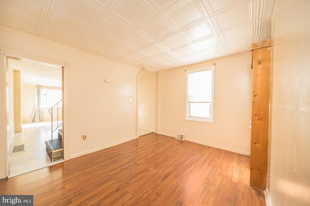 unfurnished room with wood-type flooring