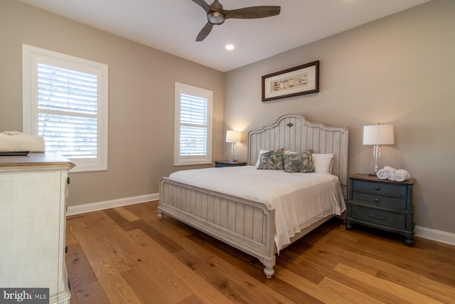 bedroom with light hardwood / wood-style flooring, multiple windows, and ceiling fan