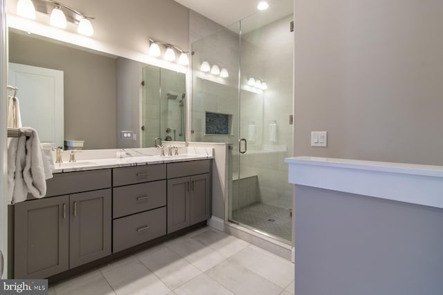 bathroom with vanity, tile patterned flooring, and a shower with door