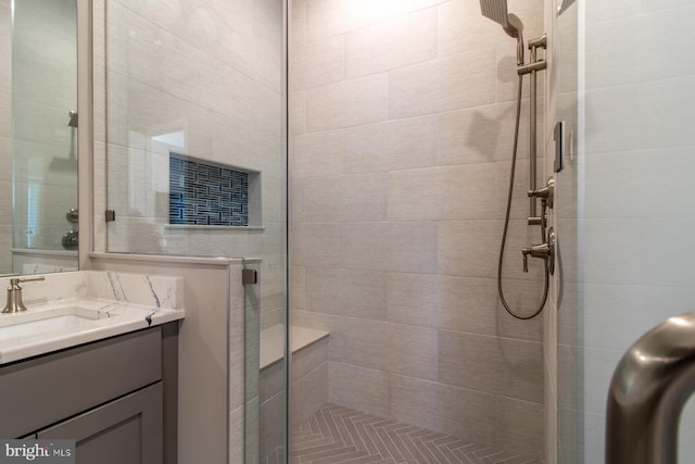 bathroom featuring vanity and a shower with shower door