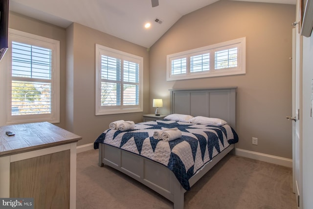 bedroom featuring multiple windows, light colored carpet, and ceiling fan