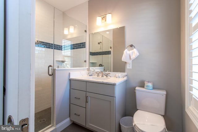 bathroom with toilet, walk in shower, and vanity