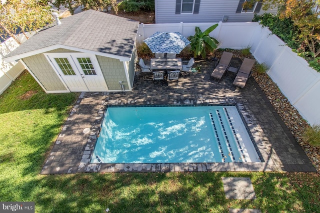 view of pool with a yard and a patio