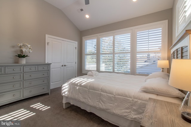 carpeted bedroom featuring vaulted ceiling and a closet