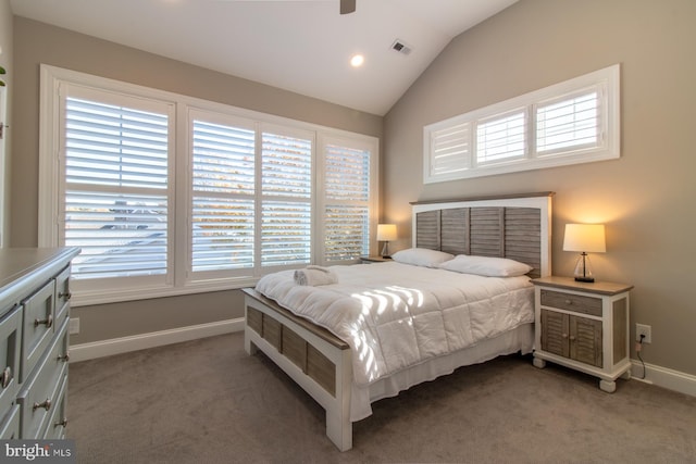 bedroom with vaulted ceiling, multiple windows, and dark colored carpet