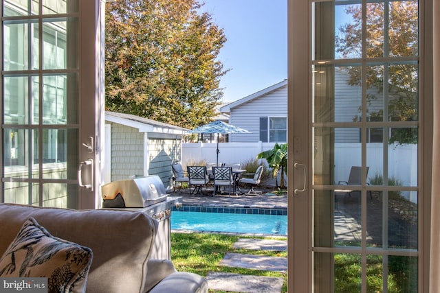 view of swimming pool featuring a grill and a patio area